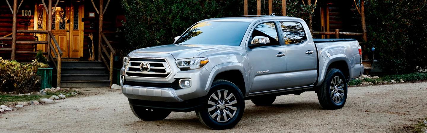 silver Toyota truck parked near log cabin