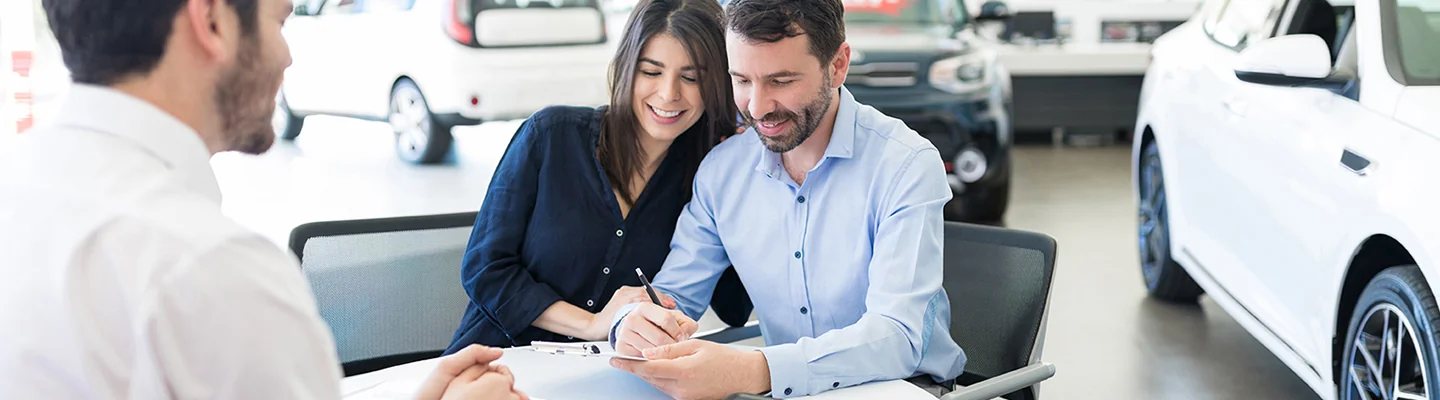Sales person talking to customers about there CDJR Warranty and protection plan
