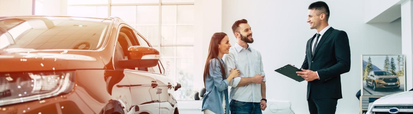 couple discus car deal with car salesman