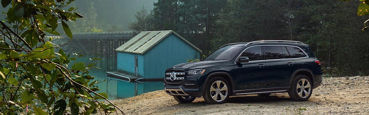 Blue 2022 Mercedes-Benz GLS parked in country by river and bridge