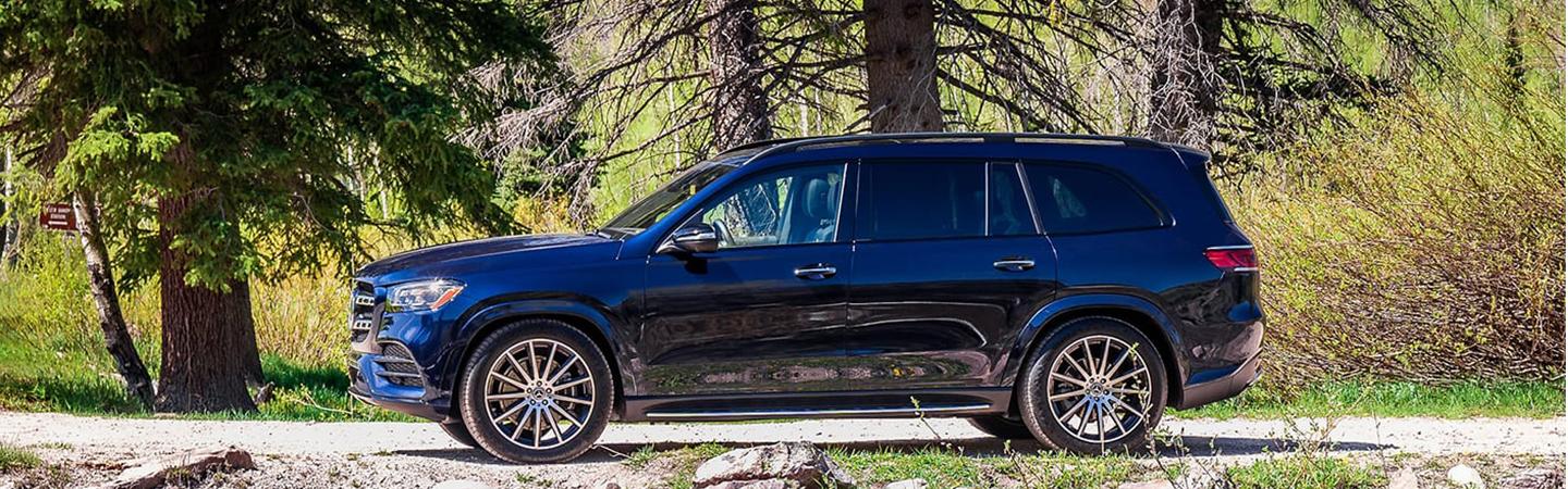 Driver side view 2022 Mercedes-Benz GLS parked on gravel road