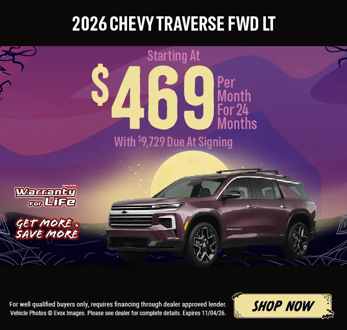 2026 Chevy Traverse FWD LT – Starting at $469 per month for 24 months with $9,729 due at signing. Dark maroon Chevrolet Traverse SUV with the Chevy bowtie logo, shown against a Halloween night background with a full moon. Includes a "Home of the Warranty for Life" logo and a "Get More & Save More" badge. For well-qualified buyers only; requires financing through a dealer-approved lender. Vehicle photos © Evox Images. Please see dealer for complete details. Expires 11/04/26. Shop Now.
