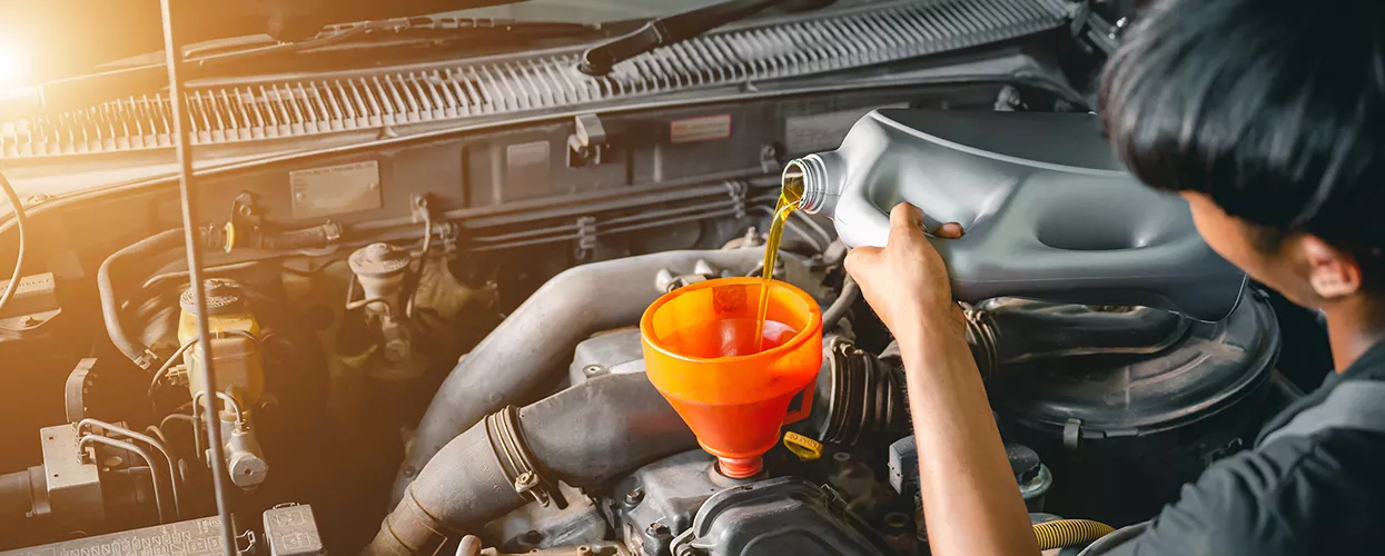 pouring fresh oil into engine