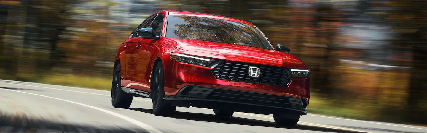 Honda Accord driving fast down road