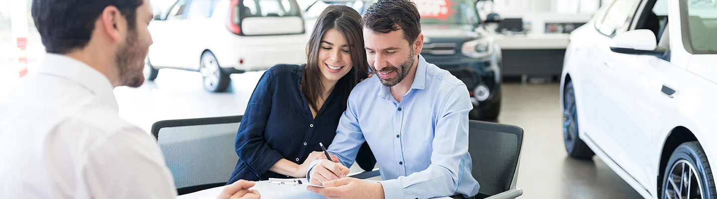 people buying new car in car showroom