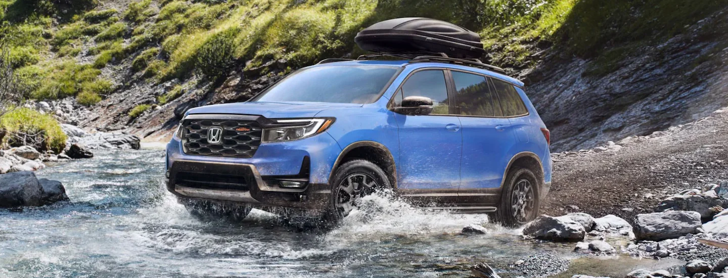 Honda Passport driving on rocks