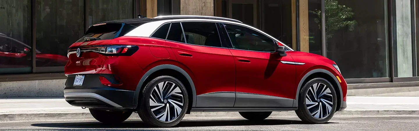 Side view of a red 2024 Volkswagen ID.4 parked in the city