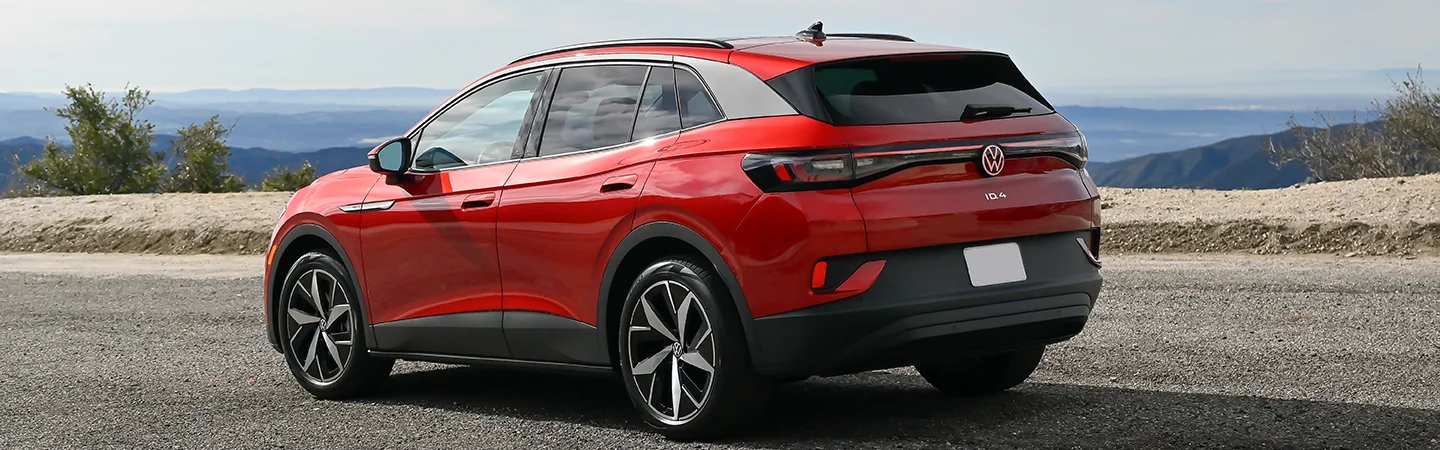 Side view of a red 2024 Volkswagen ID.4 parked on the side of the road