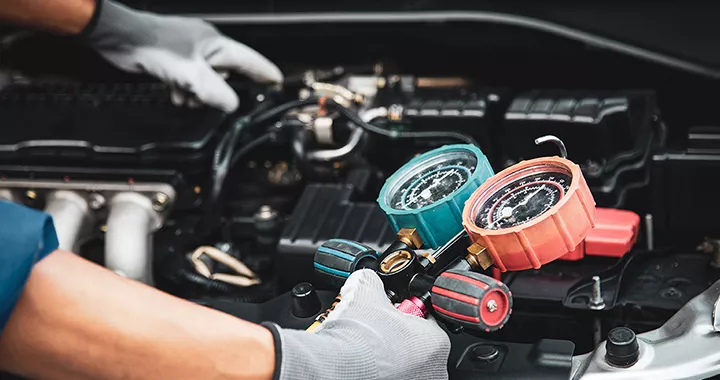 Service technician working on the engine of a vehicle