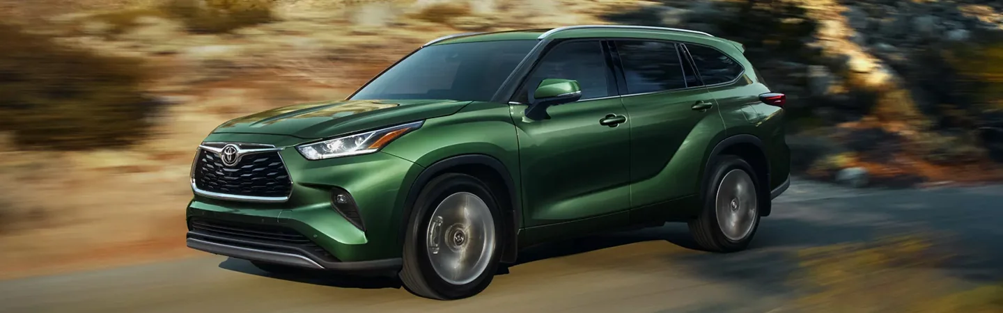 Toyota Highlander driving down dirt road