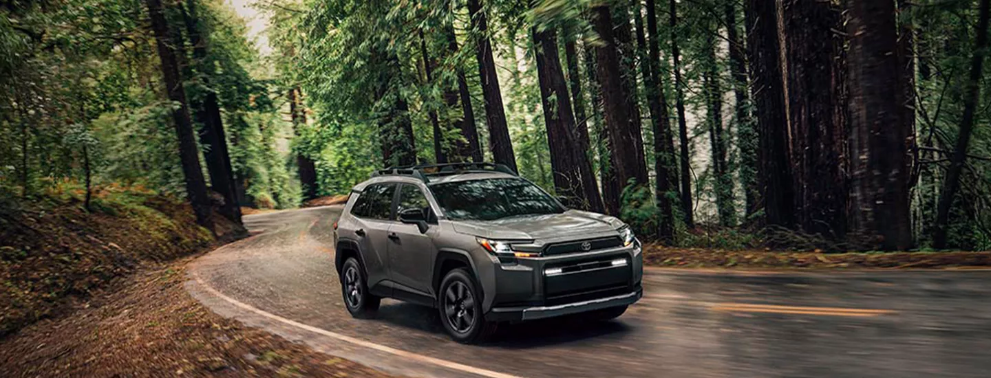 2026 Toyota RAV4 drivin through a road in the woods in Holiday, FL