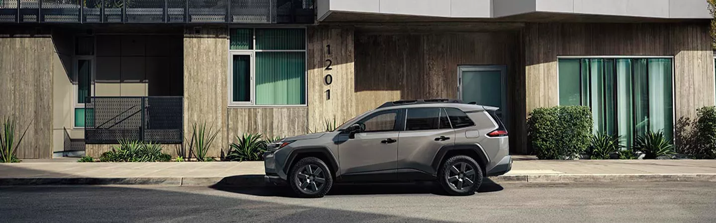2026 Toyota RAV4 parked in front of an apartment building in Holiday, FL