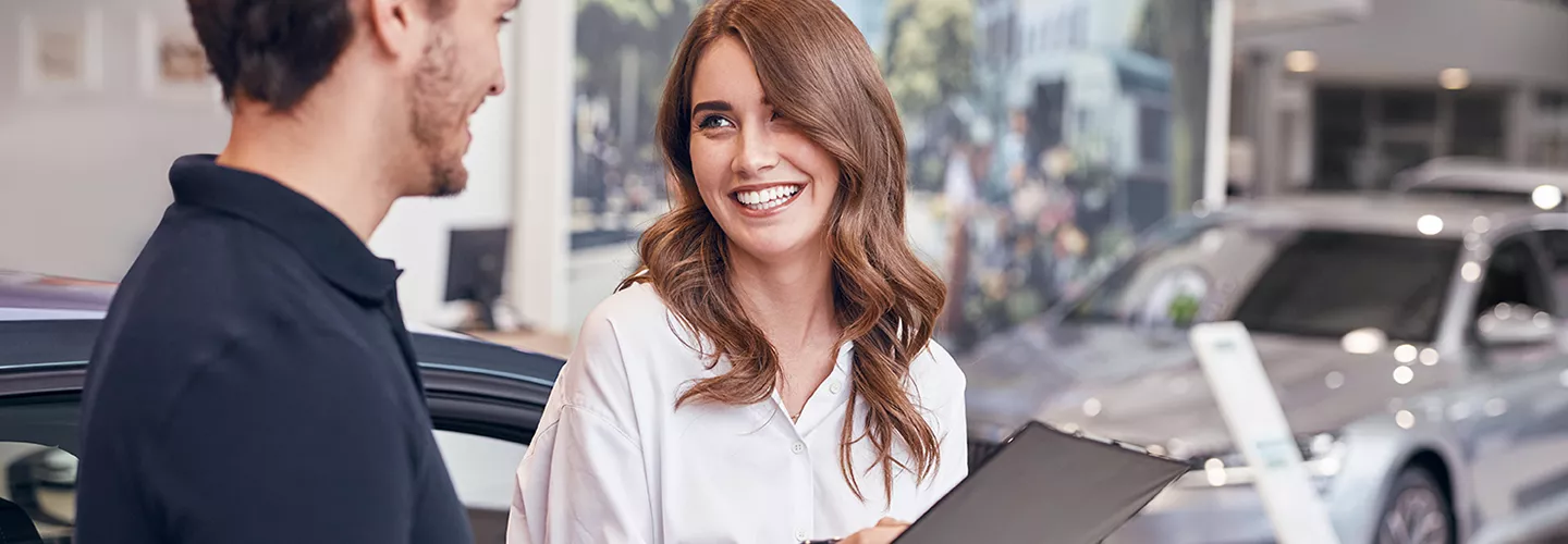 Car salesperson speaking with a customer about a new Toyota