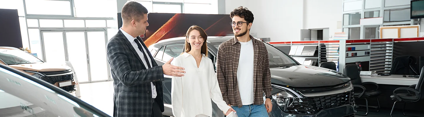 Sales person talking to customers about lease options of a new car
