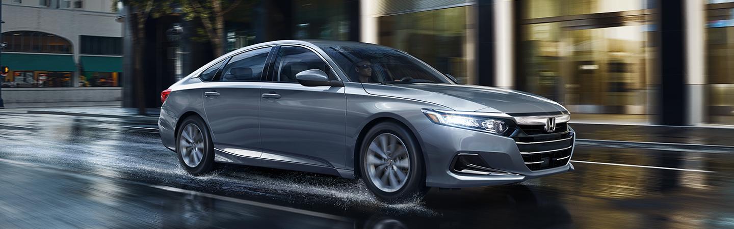 A Gray 2021 Honda Accord driving in the city