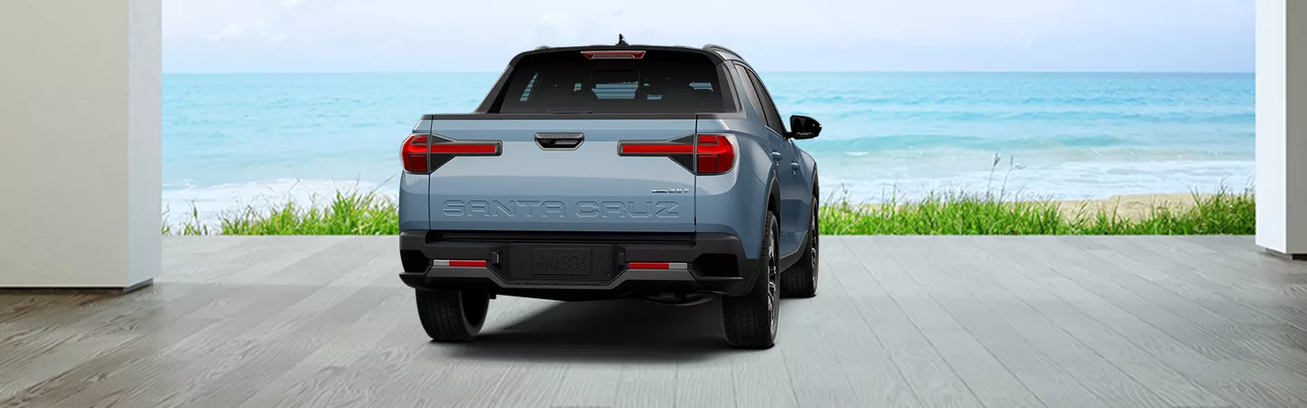 Rear view of 2026 Hyundai Santa Cruz parked in front of the ocean