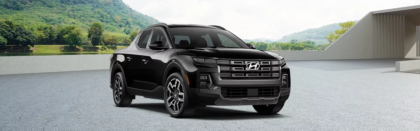 Front view of 2026 Hyundai Santa Cruz parked at a hilly beach residence
