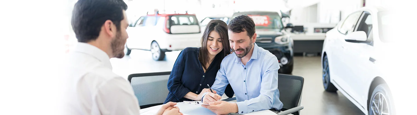 couple looking over details of a Hyundai Warranty and Protection Plan at Brandon Hyundai with car salesperson