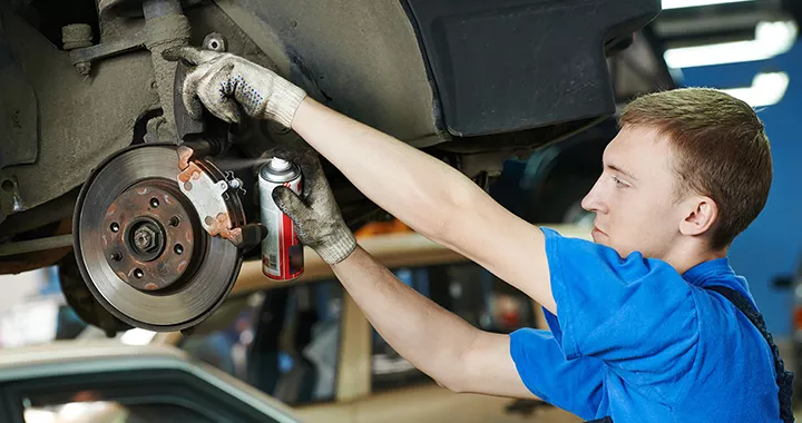 Service technician checking the brakes on a vehicle at Toyota of Tampa Bay