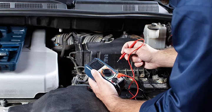 Service technician checking the battery on a vehicle at Toyota of Tampa Bay