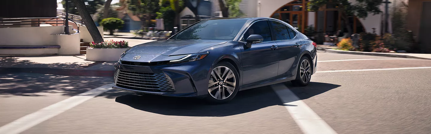 2026 Toyota Camry driving through the city in the day time