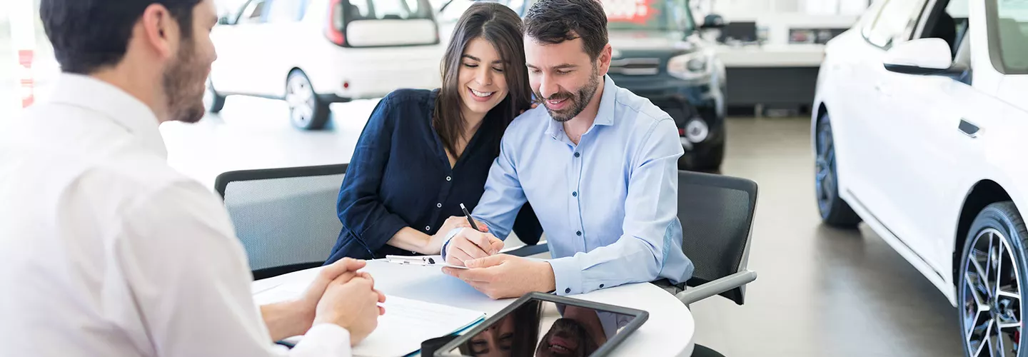 Customers sign paperwork at Toyota of Tampa Bay