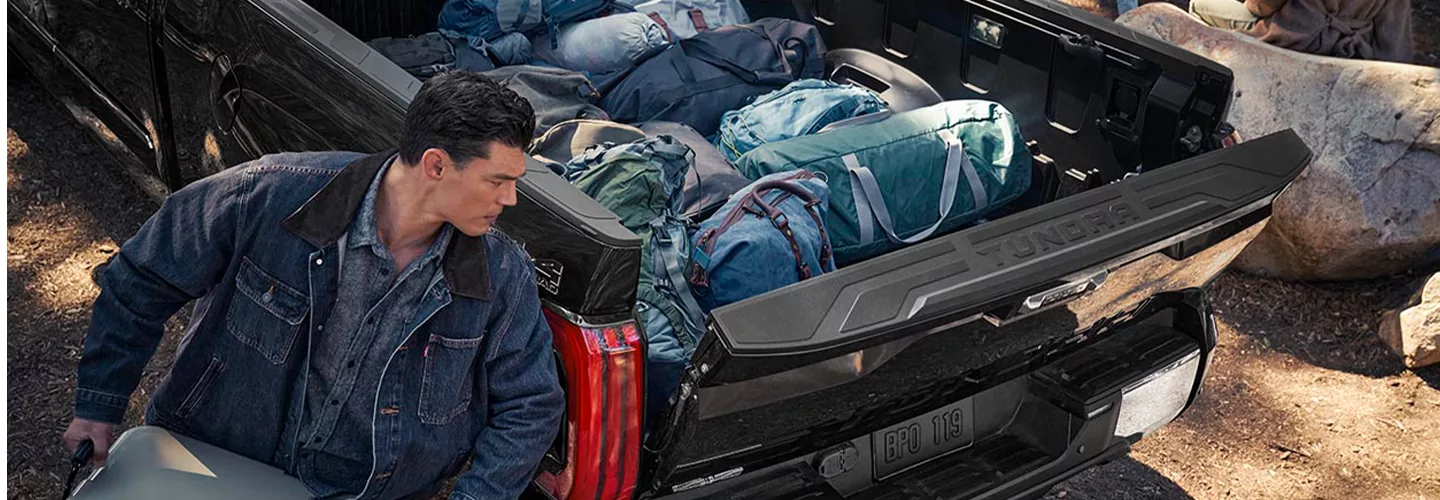 Person loading gear into the bed of a 2026 Toyota Tundra