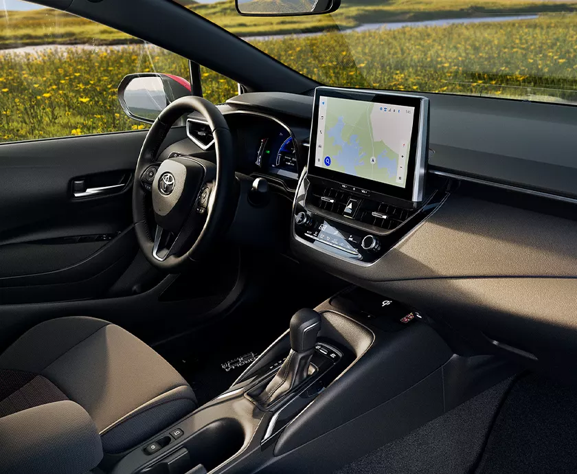 Interior view of the front seat dashboard and tech in a 2027 Toyota Corolla