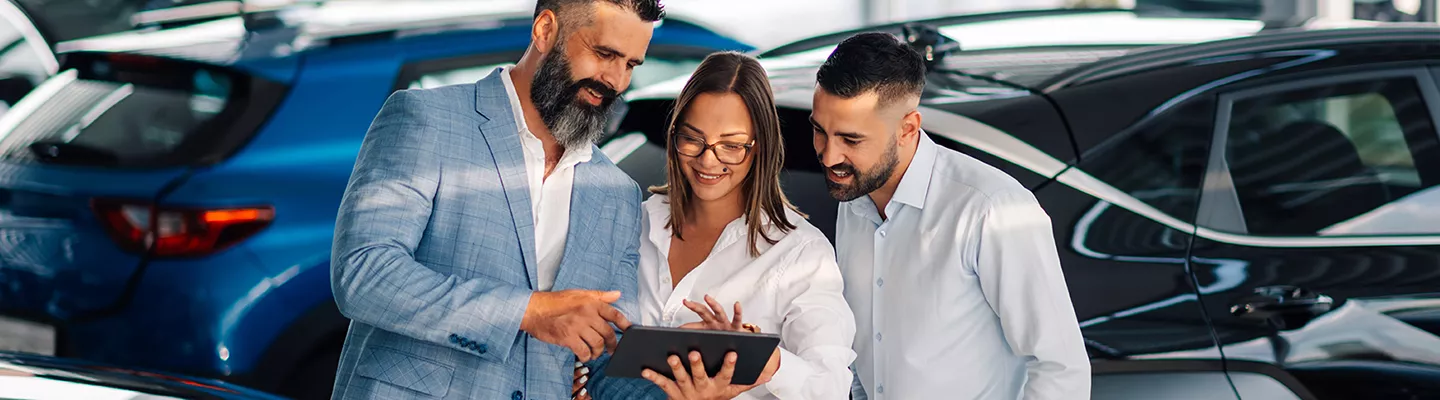 Customers looking at information on a tablet with a salesperson