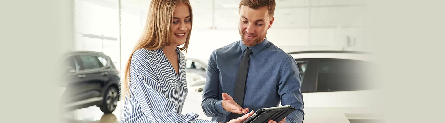 Customer speaking with a salesperson at Kia of Cape Coral