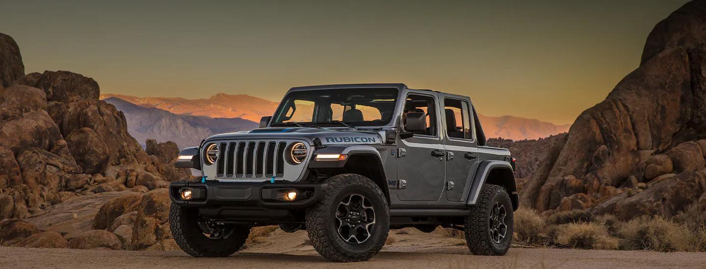 Front view of a grey Jeep Wrangler parked in the desert.