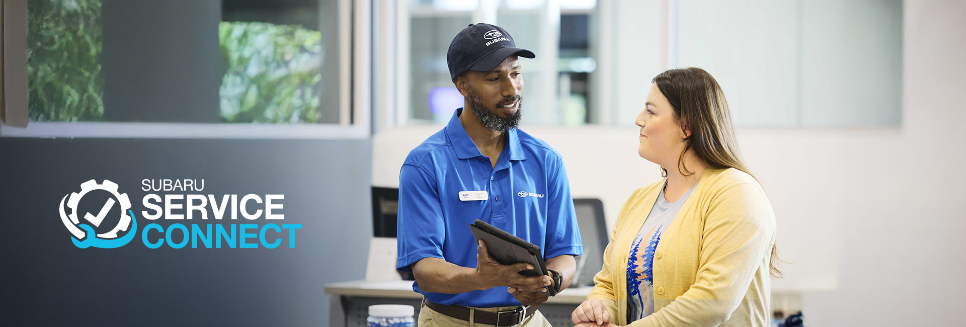 Subaru Service Connect | Specialist showing woman vehicle diagnostic