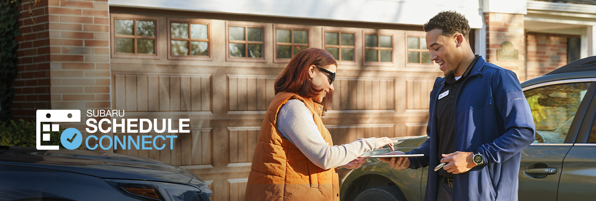 Subaru Schedule Connect | Specialist having woman sign smart device