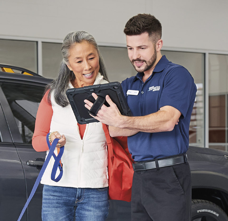mechanic showing woamn info on smart device