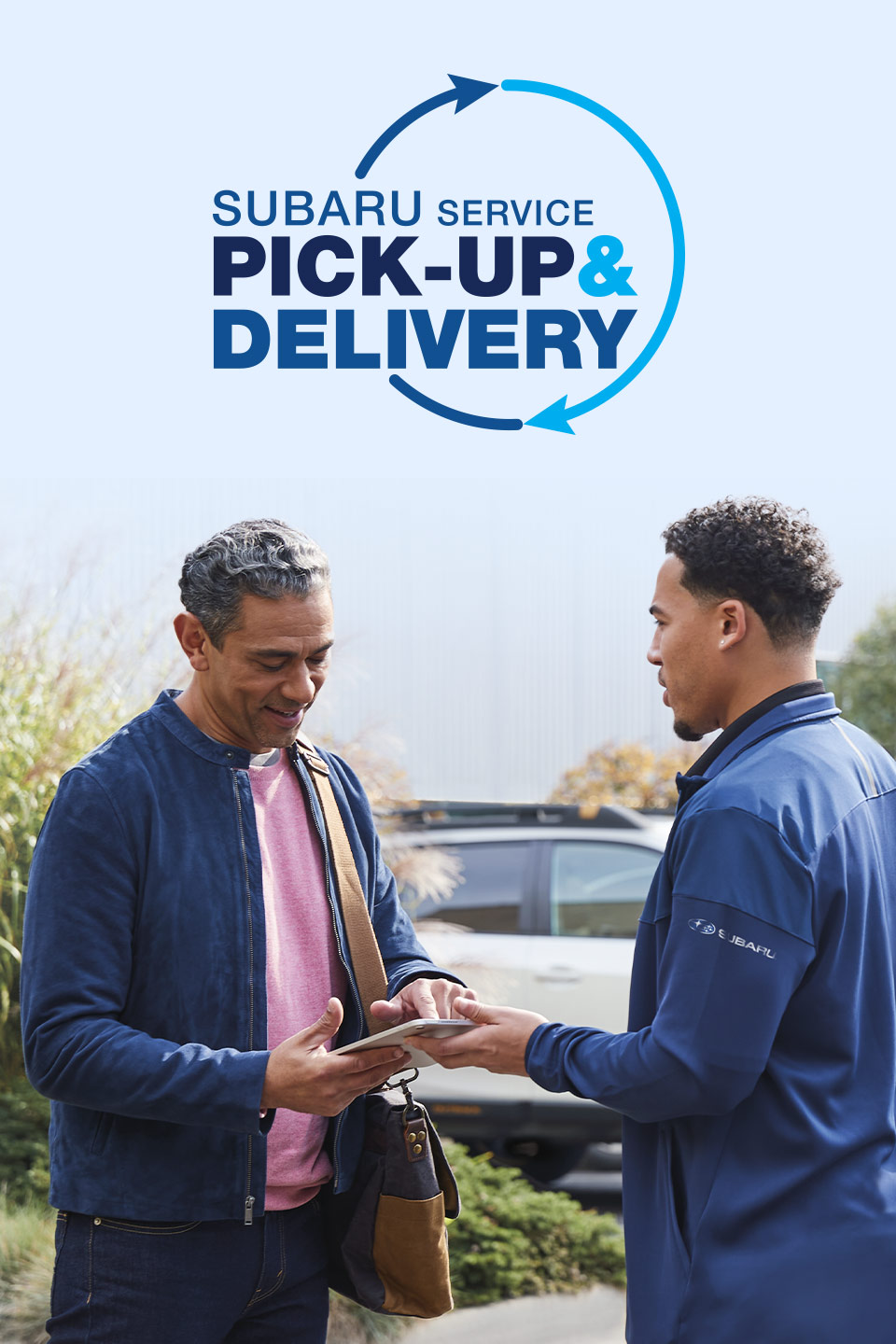 mechanic having man sign smart device with logo of Subaru Service Pickup & Delivery above