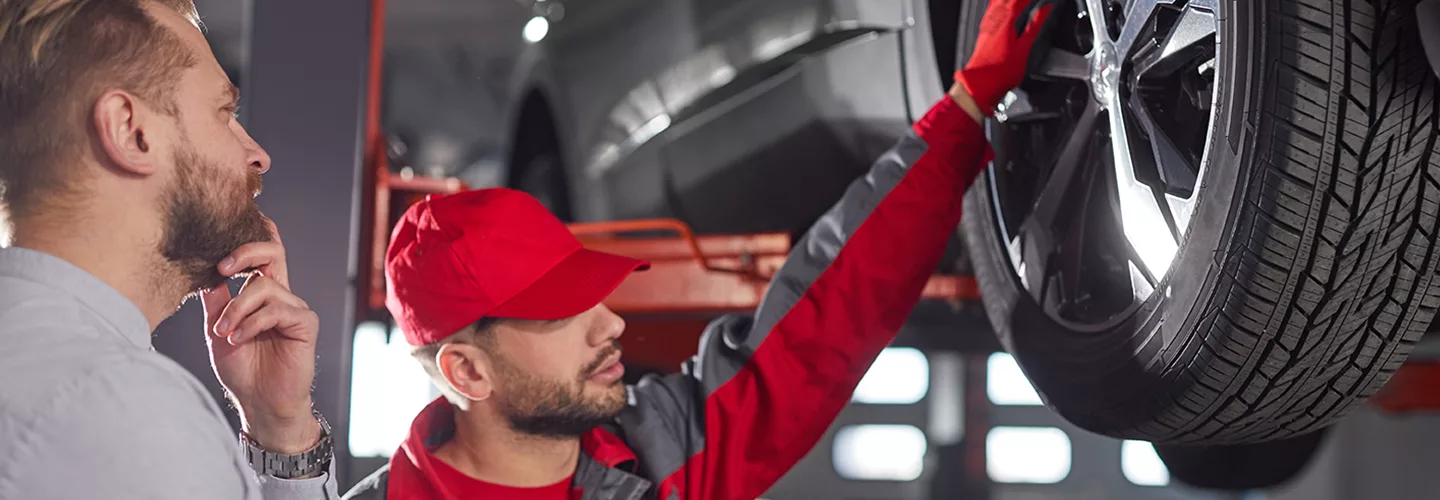 techs checking wheel and rotor
