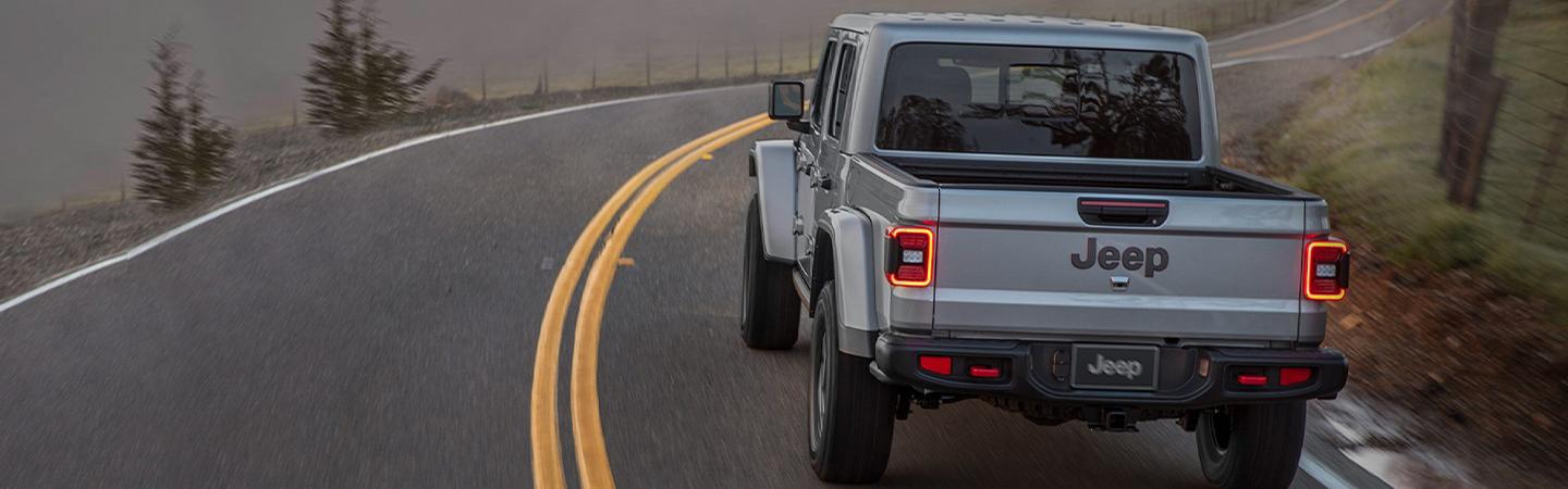 Rear view of a 2021 Jeep Gladiator in motion