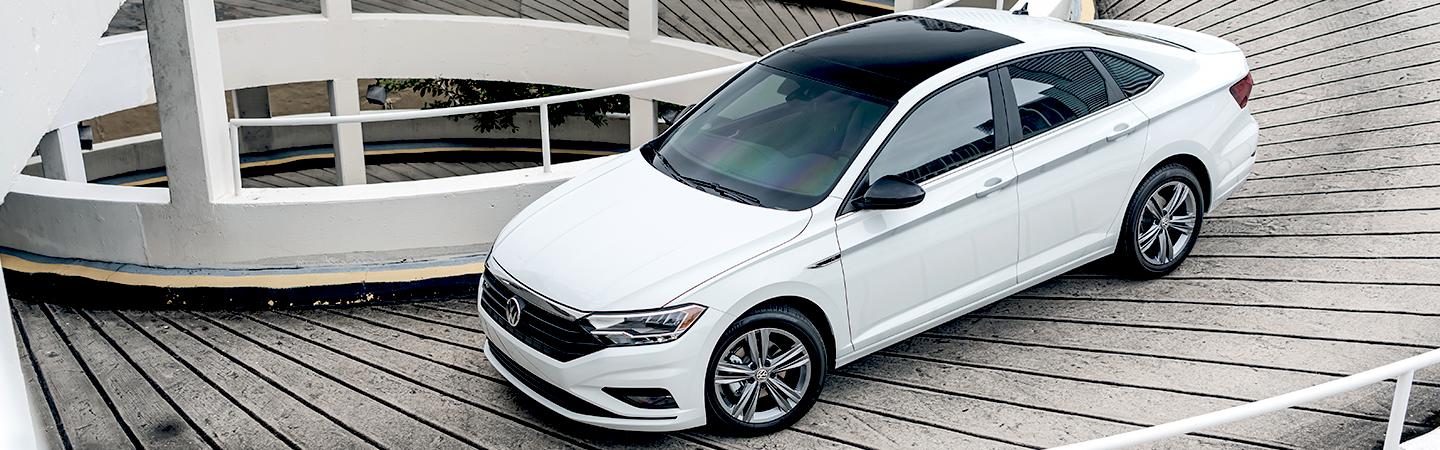 Aerial view of the 2021 Jetta driving down a driveway 