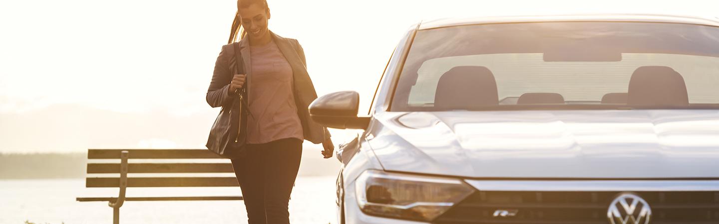 A lady walking next to the 2021 Jetta