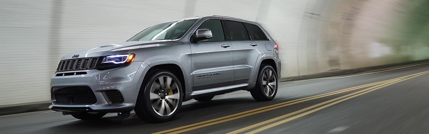 Silver Jeep Grand Cherokee in motion