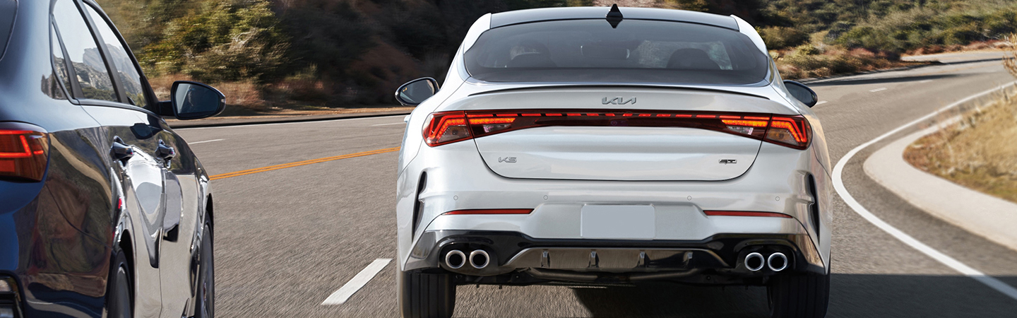 2024 Kia K5 Specs back side view in white