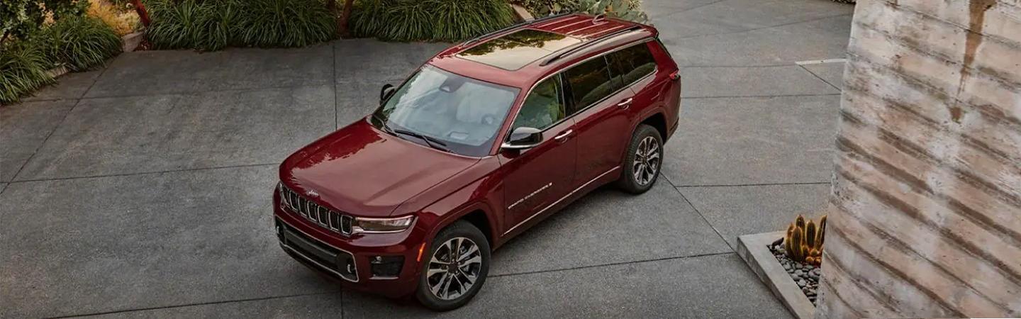 top view red 2021 Grand Cherokee L parked in driveway of home