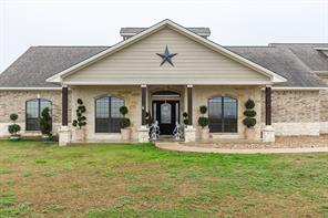 Stunning and unique custom home with adorable guest quarters on 16.27 acres has beautiful curb appeal. The main house has gorgeous, easy care, stained concrete flooring throughout the first floor. The stone fireplace in the dining room is flanked by french doors that look out to the covered patio. Cooking will be a delight in the gourmet kitchen that opens to the family room and breakfast area. The main house has 3093 square feet and boasts 4 bedrooms/3 bathrooms, and a study. The guest quarters has beautiful handscraped wood floors in the 801 sq. ft. that consists of a living area opening to the kitchen, bedroom/bath, and office