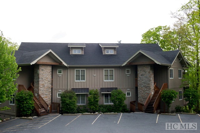 Beautiful Condominium in Old Edwards Club! Like New with freshly painted walls and new carpet. This is the most sought after floor plan in The Views with no steps going in! The main floor includes a living room with fireplace, master suite & guest bedroom, each with their own private baths, dining room, spacious kitchen, screened porch with fireplace, and an additional covered porch overlooking the mountains. Downstairs offers another living room and porch, and a second master suite and bath. Granite countertops, 10 foot ceilings throughout, stainless steel appliances, crown molding, and luxurious baths. List price includes 2015 HOA dues.Maintenance free living and the perfect place to escape the summer heat & enjoy the mountain views!