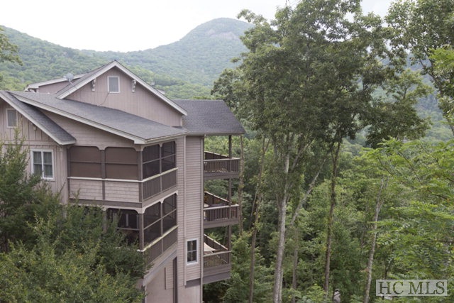 Great Views condominium in Old Edwards Club at Highlands Cove. One of few with both a mountain and golf course view! Level entry, 2 fireplaces (one in living room and one on the screened in porch). Other features include granite countertops, hardwood floors, stainless steel appliances, extra family room and/or office downstairs and two full master suites.