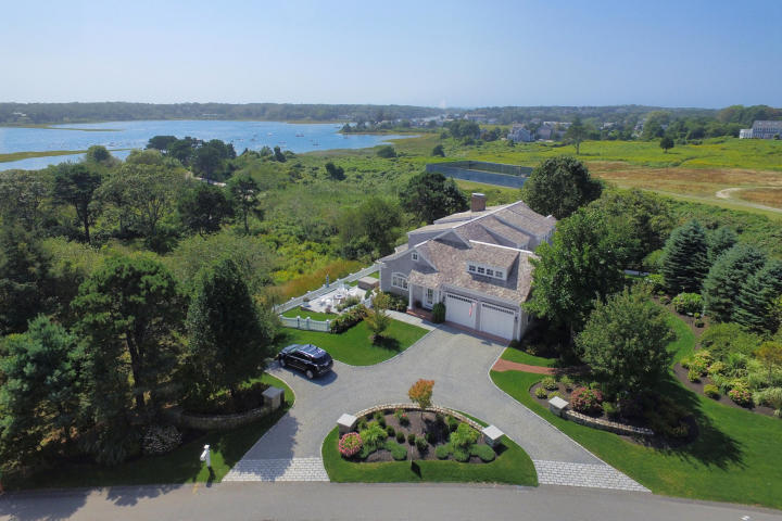 (BUYER REPRESENTATIVE. Listing information provided courtesy of Pine Acres Realty.)   Set in a private Chatham enclave minutes from town and Harding's Beach, this pristine home epitomizes Cape Cod lifestyle. With lovely vistas of Oyster River, the home welcomes an exceptional open floor plan with the finest craftmanship and generous living spaces. Perfectly designed, the main level flowing layout comprises a chef’s kitchen, living room with gas fireplace open to a deck, a formal dining room, laundry, mudroom, home office and an elegant master suite. Above is a light filled family room with fireplace & deck and three bedrooms with two full baths. Light-filled with a southern exposure, this turnkey offering was recently enhanced with an extensive stone patio, a fire pit, state of the art appliances and backsplash, window treatments, new paint, utility upgrades and more.