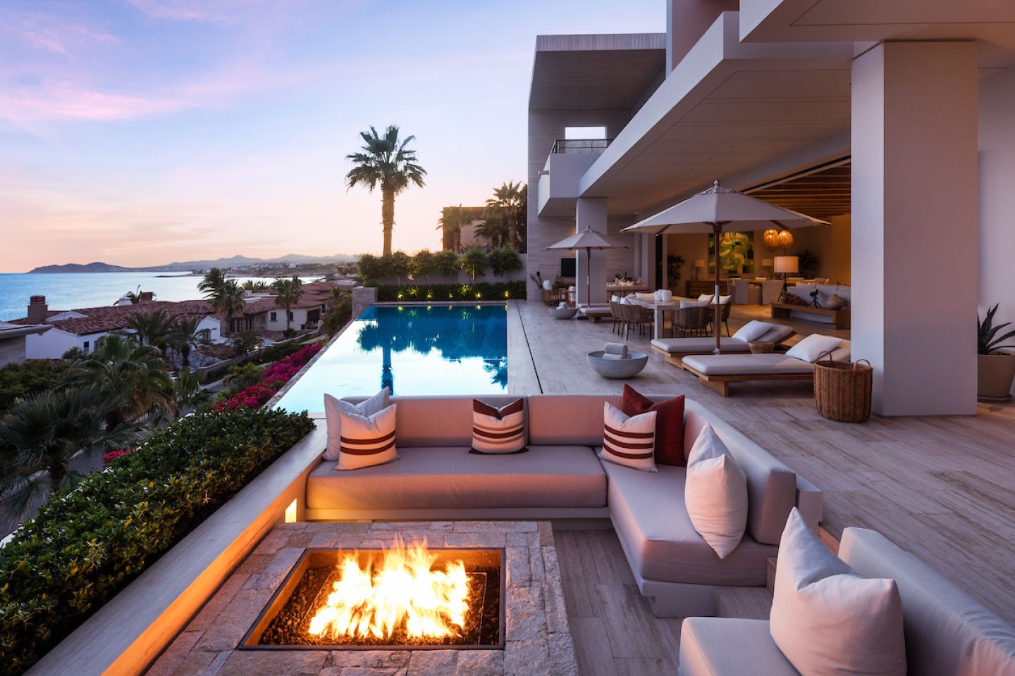 This beautiful five bedroom contemporary home, features the latest in luxury with modern finishes, fixtures and master craftsmanship throughout. The open kitchen includes top-of-the-line appliances with a stunning view of the Sea of Cortez. In addition to the three ocean view master suites, there is a media room, and two guests suites. The pool/patio area is enhanced by an outdoor kitchen and dining area with fire and water features, providing a seamless blend of the outside entertainment area with the indoor living room. 