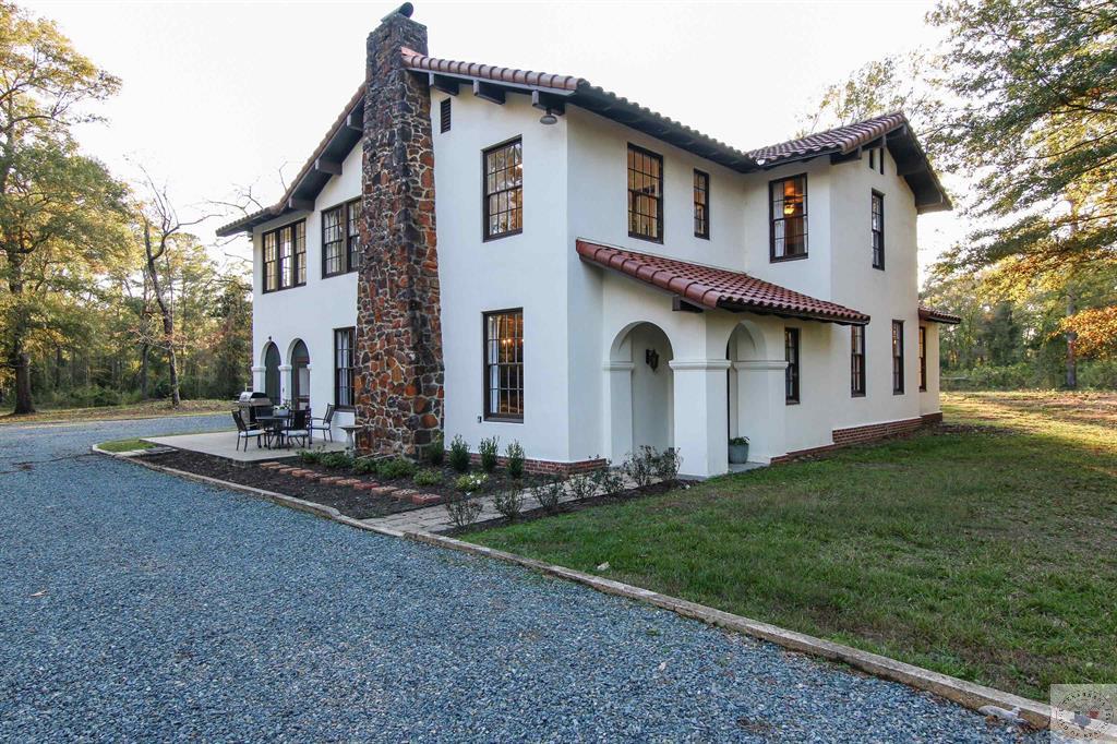 Built in 1935 on four acres of land right in the middle of the city, this home is sure to please most anyone! This home boasts of it all! Five bedrooms and 2.5 bathrooms, a formal dining, laundry room with a pet washing station, a kitchen and a breakfast area all spread out over two-stories. The primary bedroom has a sunroom off it that would be great for a home office or gym. The owner recently completed an extensive remodel which included all new electrical brought up to code, all new plumbing brought up to code, a brand-new clay tile roof, completely re-done bathrooms and kitchen, all new flooring and paint, and so much more!! They salvaged all the existing items they could such as the windows, light fixtures, and floor plan to keep the home as original as they could while accommodating today's needs. The home also features a small 330 SF guest house with a kitchen, bathroom, and bedroom/living room. Plus, a small storage building and a screened in porch that is to die for. You will love the seclusion and convenience of being close to everything at the same time! Call today to schedule a tour and make this home yours.