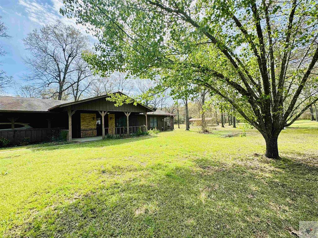 Pulling up to this property you will be awed by the beautiful acreage it sits on. Large trees shade a lovely creek that spills into a small pond. There is a covered pavilion that has all the hookups you need for an outdoor kitchen making it the destination for your gatherings. There is a small shop as well. Inside you’ll find huge walk in closets and a big open concept living space. The kitchen is massive but the master closet is unreal in size. The house has been loved for years by the same family, and now its your turn to make this house your home.