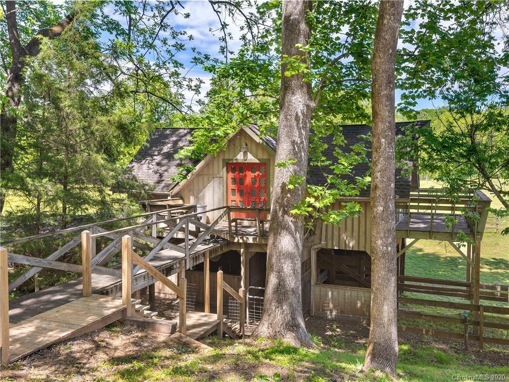 Listing courtesy of Sotheby's Keller Williams Professionals. Rare 32 acre private horse farm on the Pacolet River in the desirable Hunting Country area w/ direct access to the FETA trail system (150 miles) adjacent to FENCE. Income producing potential, full of possibilities, a true equestrians dream! This property features 2 homes, studio/office building, barn w/ potential for apartment above, workshop, total of 11 stalls (potential for 6 more), fenced pastures, 200' x 100' lighted arena, 60' round pen & run-in barn with center feeder. The stylish and sophisticated House over Barn has +2400 SQFT of living space (3 BR/2 BA) above the 5 stall barn complete with 16' aisle with tack room/groom's quarters, full bath & laundry. The 200+ yr. old historic cabin w/ 4 fireplaces, stone patio & porches creates an ideal 2nd living quarters and +2600 SQFT. The studio/office building has 4 stalls, feed/tack room & round bail feeder. Located 5 mins to Tryon/ Landrum, 15 mins from TIEC, 30 mins to GSP & AVL airports. Check RE-5 (estate/agri) zoning uses.